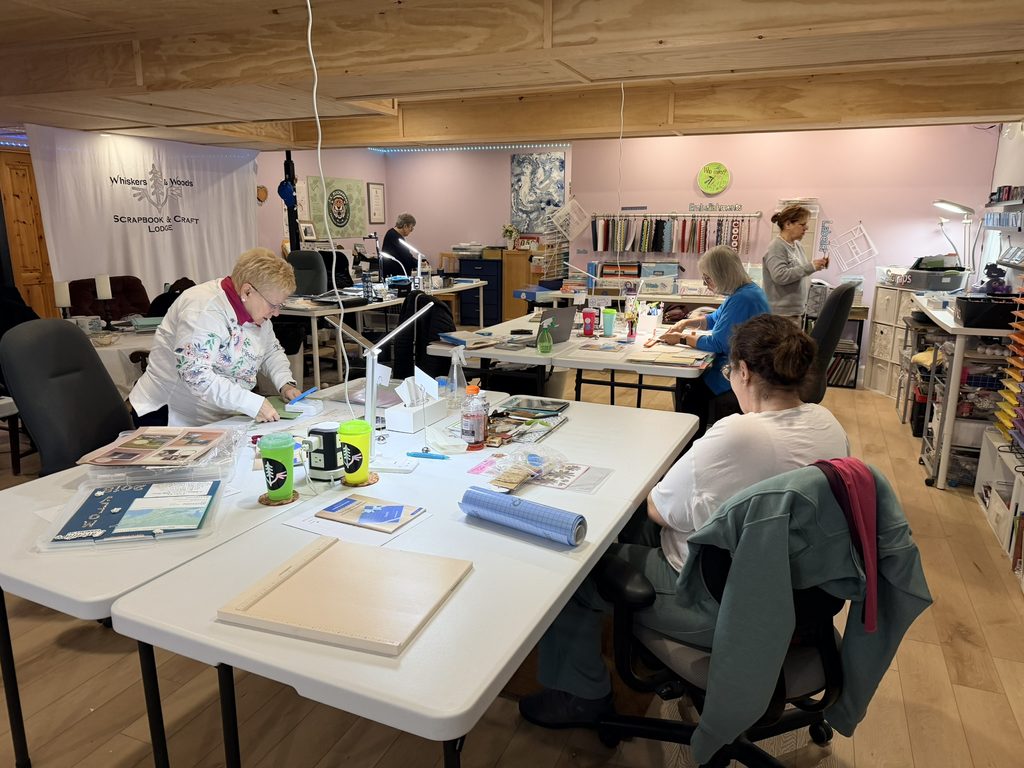 Guests enjoying a weekend scrapbook retreat at Whiskers & Woods