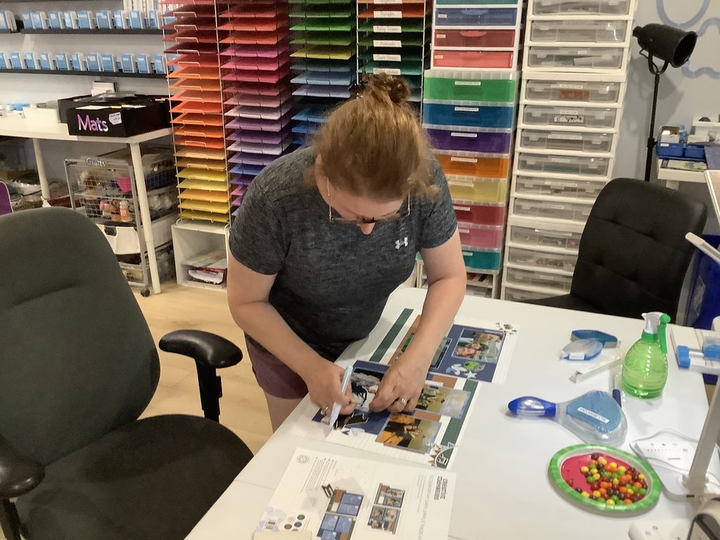 Guest working on a scrapbook project during a creative crop